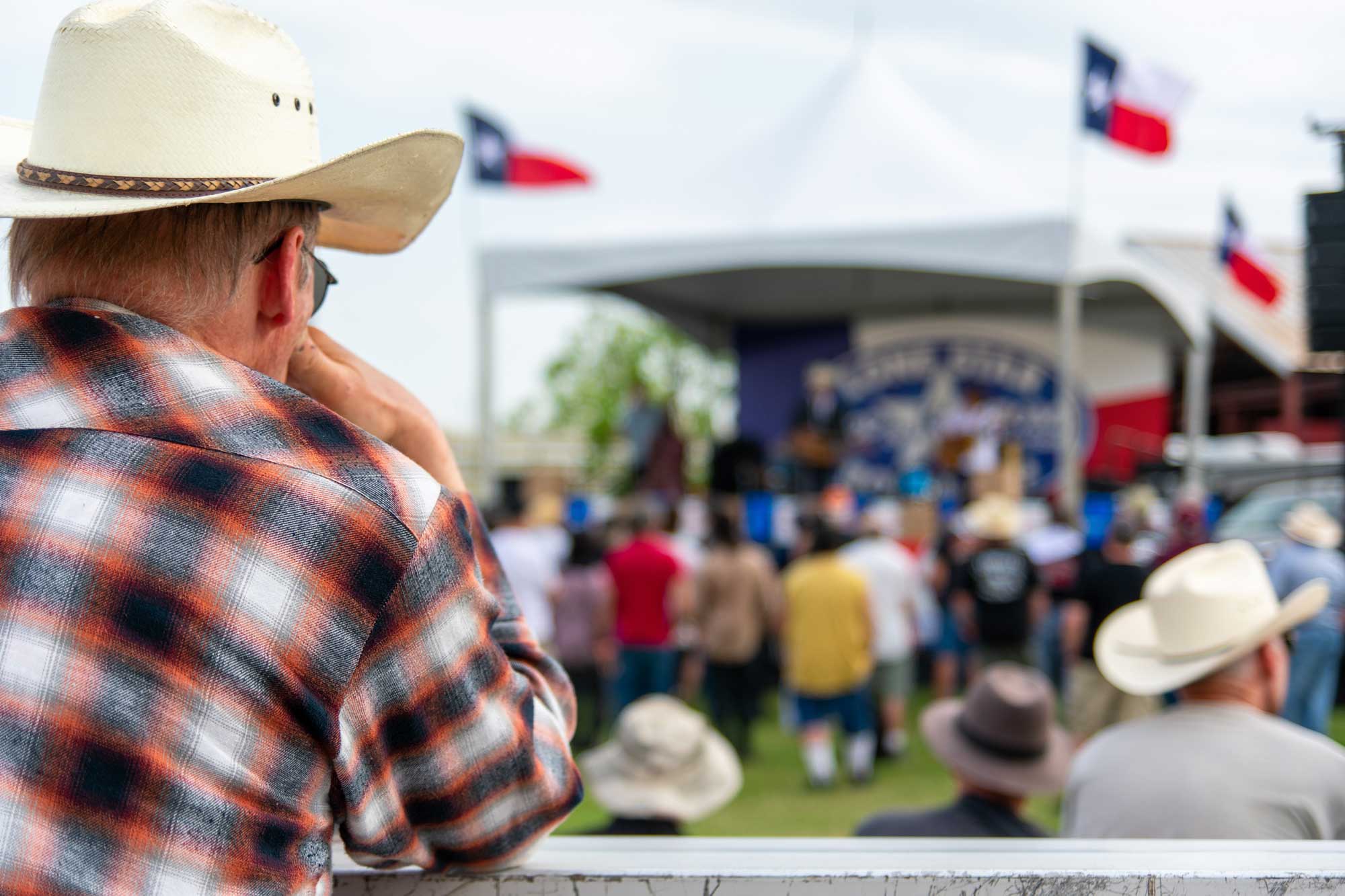 a-spectator-watches-as-junior-brown-and-his-band-perform-at-a-vintage-car-show-near-austin