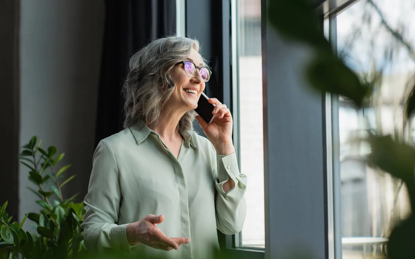 Positive businesswoman taking on phone