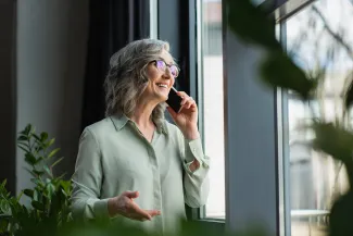 Positive businesswoman taking on phone