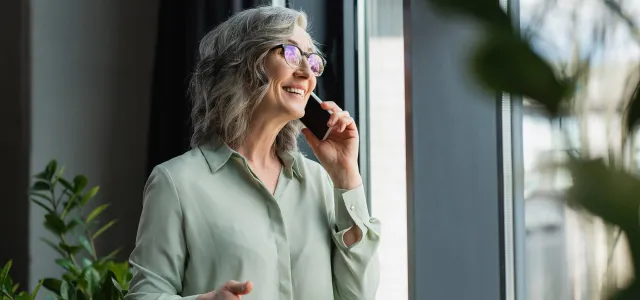 Positive businesswoman taking on phone